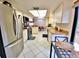 Well-lit kitchen with stainless steel appliances and a view of the dining room at 1407 Willow Oak Cir, Bradenton, FL 34209
