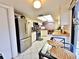 Bright kitchen with stainless steel appliances and a view of the dining area at 1407 Willow Oak Cir, Bradenton, FL 34209