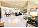 Expansive living room with an open layout, tile floors, high ceilings, and views of the dining and kitchen areas at 1407 Willow Oak Cir, Bradenton, FL 34209