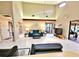 Inviting living room with tile floors, high ceilings, wooden beams, and access to the backyard and other rooms at 1407 Willow Oak Cir, Bradenton, FL 34209