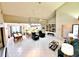 Spacious living room with tile flooring, vaulted ceilings, and an open layout with dining and kitchen views at 1407 Willow Oak Cir, Bradenton, FL 34209