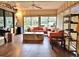 Bright living room with hardwood floors, an orange sofa, and large windows offering natural light at 1407 Willow Oak Cir, Bradenton, FL 34209