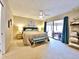 Spacious main bedroom featuring a king-sized bed and a slider to the outdoor patio at 1407 Willow Oak Cir, Bradenton, FL 34209