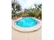 An in-ground pool with surrounding concrete deck and trees with lawn chairs and perimeter fencing at 1407 Willow Oak Cir, Bradenton, FL 34209