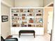 Built-in shelving unit with cabinets underneath and wood bench seat at 1407 Willow Oak Cir, Bradenton, FL 34209