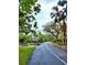 View of street lined with mature trees and landscaping, creating a shaded and inviting community at 1407 Willow Oak Cir, Bradenton, FL 34209