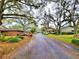Exterior neighborhood street scene with mature trees and landscaping, creating a peaceful atmosphere at 1407 Willow Oak Cir, Bradenton, FL 34209