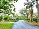 A street view featuring mature trees and landscaping that create a peaceful, welcoming atmosphere at 1407 Willow Oak Cir, Bradenton, FL 34209