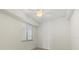 Bedroom featuring large window with blinds and a ceiling fan at 16904 Vardon Ter # 102, Bradenton, FL 34211