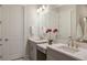 Bathroom featuring double sinks, stone countertops, gray cabinets, and modern fixtures at 3023 Vittorio Ct, Lakewood Ranch, FL 34211