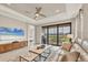 Comfortable living room with tile floors, ceiling fan, and sliding glass doors leading to a screened-in patio at 3105 Formia Ct, Bradenton, FL 34211