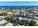 Aerial view of blue coastal home surrounded by mature landscaping, near the ocean and town at 312 61St St # A, Holmes Beach, FL 34217