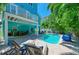 Outdoor living space with a pool, lounge chairs, and a dining area at 312 61St St # A, Holmes Beach, FL 34217