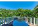 Outdoor living space with a dining table and lush tropical landscaping at 312 61St St # A, Holmes Beach, FL 34217