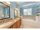 Bathroom with double vanity, a soaking tub, and built in shelving at 312 61St St # A, Holmes Beach, FL 34217