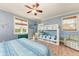 Bedroom featuring bunk beds, a ceiling fan, and coastal-themed decor at 312 61St St # A, Holmes Beach, FL 34217