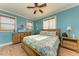 Bedroom with a ceiling fan, and a TV with ocean-themed wall decor at 312 61St St # A, Holmes Beach, FL 34217