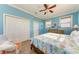 Bright bedroom features wood floors, a ceiling fan, closet, and two windows at 312 61St St # A, Holmes Beach, FL 34217
