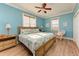 Comfortable bedroom with wood floors, ceiling fan, closet, and windows for natural light at 312 61St St # A, Holmes Beach, FL 34217