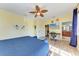 Bright bedroom with wood floors and an adjacent desk/vanity area leading to the ensuite bathroom at 312 61St St # A, Holmes Beach, FL 34217