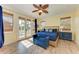 Sunny bedroom features wood floors, ceiling fan, and french doors to an outdoor balcony at 312 61St St # A, Holmes Beach, FL 34217