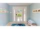 Bright entryway with a tiled floor, decorated door with sidelights, and coastal decor at 312 61St St # A, Holmes Beach, FL 34217