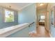Upstairs hallway with blue walls leading to the bedroom at 312 61St St # A, Holmes Beach, FL 34217