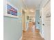 Hallway with wood floors leads past bedrooms towards a sitting area and stairs at 312 61St St # A, Holmes Beach, FL 34217