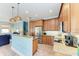 Kitchen featuring wood cabinets, stainless appliances, and granite countertops, open to living area at 312 61St St # A, Holmes Beach, FL 34217