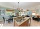 Open kitchen with island, double sinks, stone counters, and stainless appliances at 312 61St St # A, Holmes Beach, FL 34217