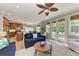 Open-concept living room with wood floors, ceiling fan, and French doors leading to an outdoor space at 312 61St St # A, Holmes Beach, FL 34217