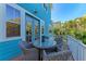 Outdoor patio featuring a wicker table and chairs with a lush tropical landscape view at 312 61St St # A, Holmes Beach, FL 34217