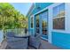 Outdoor patio featuring a wicker table and chairs with a lush tropical landscape view at 312 61St St # A, Holmes Beach, FL 34217