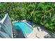 Aerial view of a backyard pool surrounded by lush tropical landscaping at 312 61St St # A, Holmes Beach, FL 34217