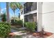 Attractive condo featuring a ground floor screened-in patio and mature landscaping at 5641 Midnight Pass Rd # 903, Sarasota, FL 34242