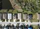 Aerial view of houses on a street showing rooftops, driveways and surrounding landscapes at 5718 Broad River Run, Ellenton, FL 34222