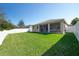 Spacious backyard featuring a lush lawn and white fence at 5718 Broad River Run, Ellenton, FL 34222