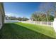 Spacious backyard featuring a lush lawn and white fence at 5718 Broad River Run, Ellenton, FL 34222