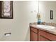 This bathroom features a vanity with a granite countertop, a mirror, and decorative art on the walls at 5718 Broad River Run, Ellenton, FL 34222