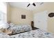 Bright bedroom with two twin beds, ceiling fan, and natural light at 5718 Broad River Run, Ellenton, FL 34222