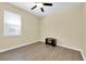 This bedroom offers a ceiling fan, a large window for natural light, and ample closet space at 5718 Broad River Run, Ellenton, FL 34222