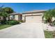 Charming single-story home featuring a two-car garage, manicured lawn and mature landscaping at 5718 Broad River Run, Ellenton, FL 34222