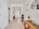 Bright entryway featuring tile flooring, accent tables, and decorative wall art at 5718 Broad River Run, Ellenton, FL 34222