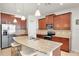 Gourmet kitchen features a large island, stainless steel appliances, granite countertops, and ample cabinet space at 5718 Broad River Run, Ellenton, FL 34222