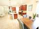 Open-concept kitchen with stainless steel appliances and connected dining area with seating at 5718 Broad River Run, Ellenton, FL 34222