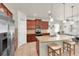 This gourmet kitchen features an island with seating, stainless steel appliances, and granite countertops at 5718 Broad River Run, Ellenton, FL 34222