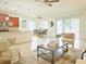 Open floor plan with living room, dining area, and kitchen featuring tile flooring at 5718 Broad River Run, Ellenton, FL 34222