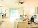Open living room with tile floors, neutral furniture, and sliding glass doors at 5718 Broad River Run, Ellenton, FL 34222