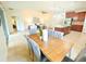Open floor plan with living room, dining area, and kitchen featuring tile flooring at 5718 Broad River Run, Ellenton, FL 34222