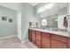 The main bathroom has double sinks, a granite countertop, and a glass-enclosed shower at 5718 Broad River Run, Ellenton, FL 34222